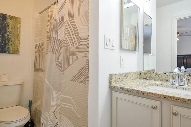 a bathroom with a toilet and shower