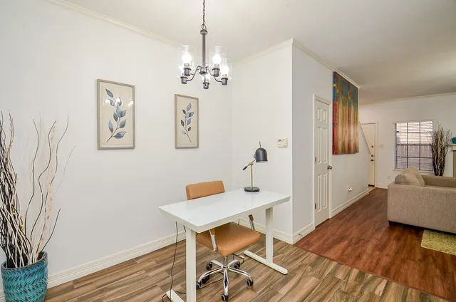 a view of a livingroom with furniture wooden floor and a chandelier