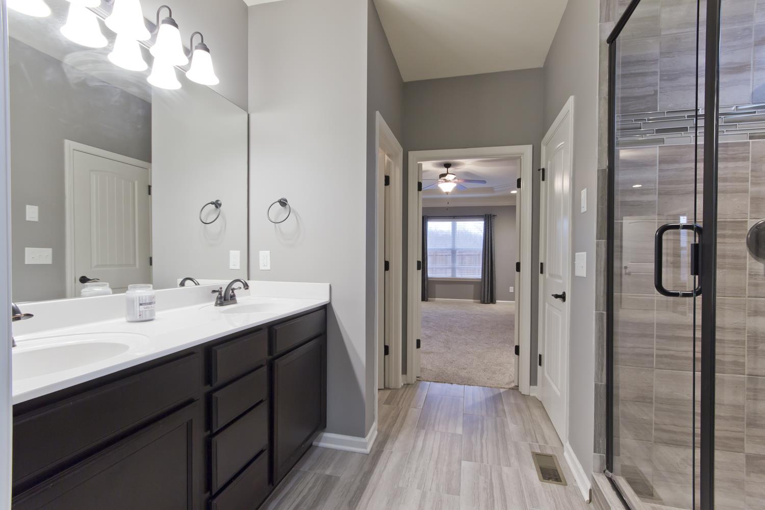 1011 Kyle Road Spring Hill, TN 37174 - Photo 14 of 30 a en suite bathroom with a sink mirror and shower