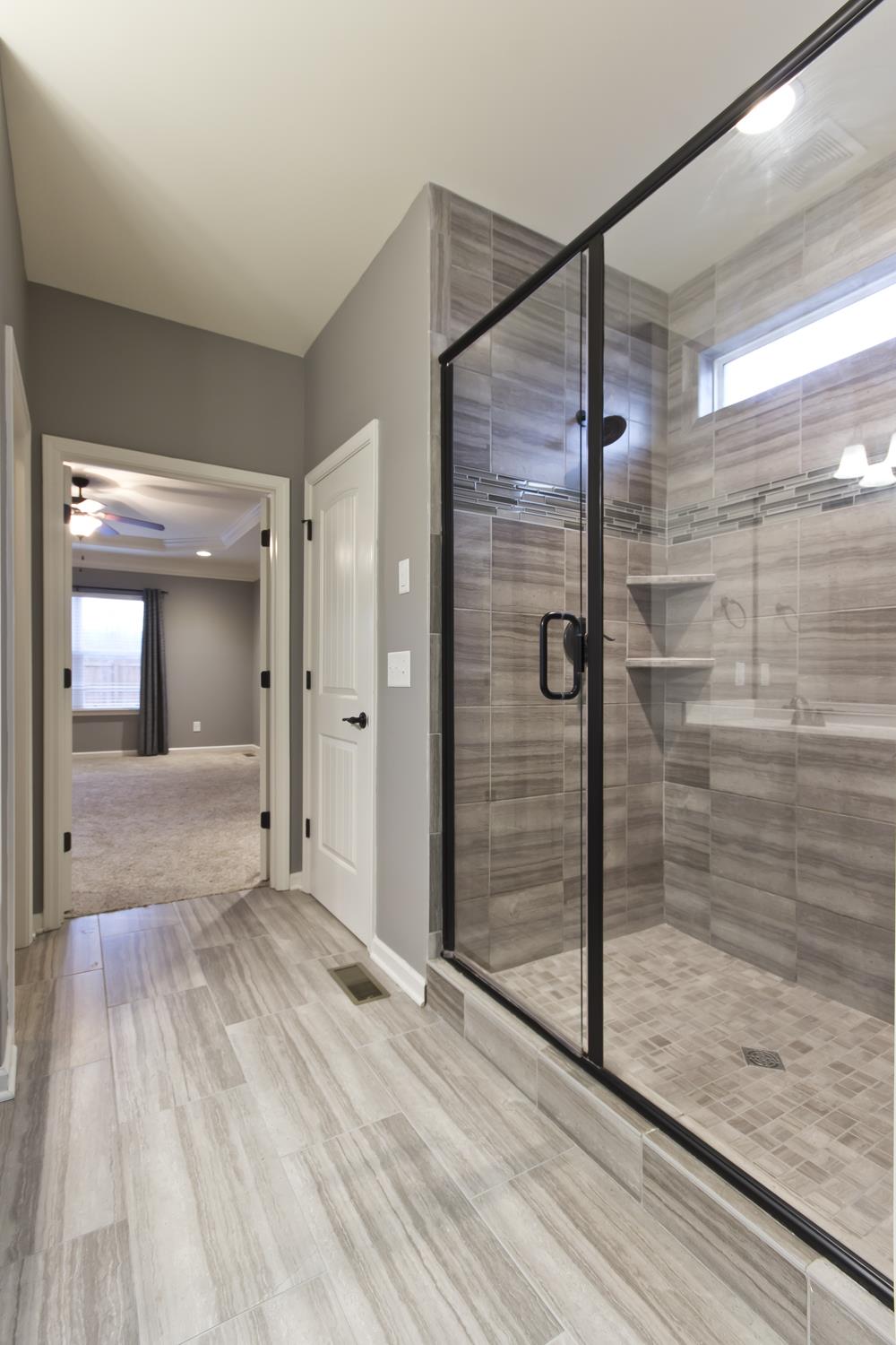 1011 Kyle Road Spring Hill, TN 37174 - Photo 15 of 30 a bathroom with a glass shower door