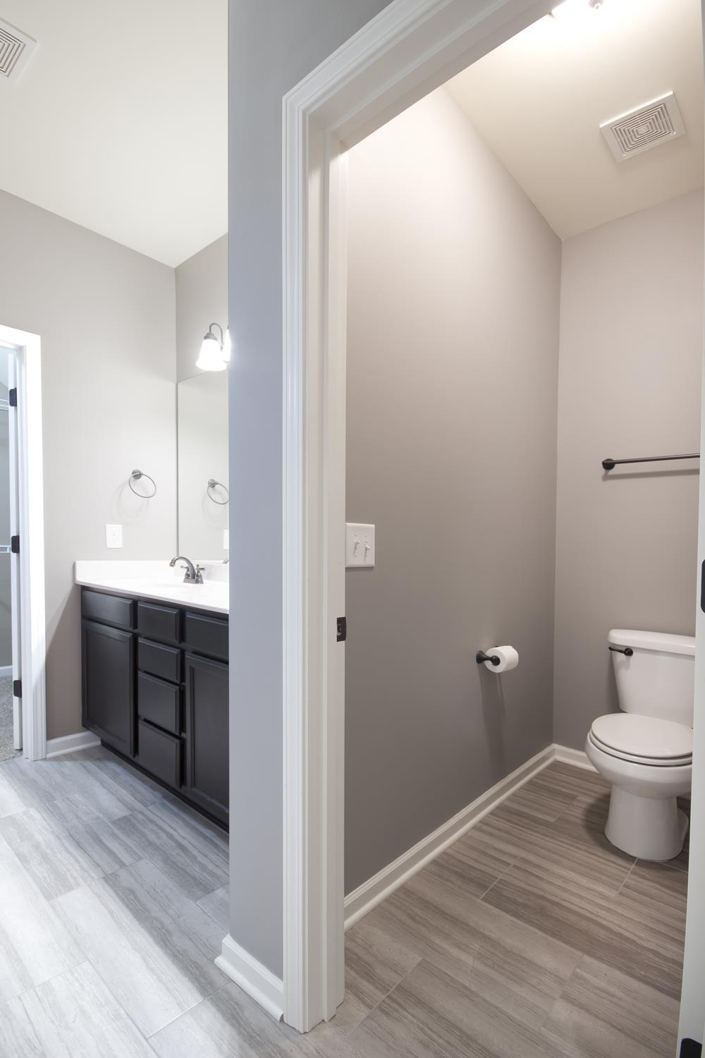 1011 Kyle Road Spring Hill, TN 37174 - Photo 16 of 30 a bathroom with a granite countertop sink toilet and shower