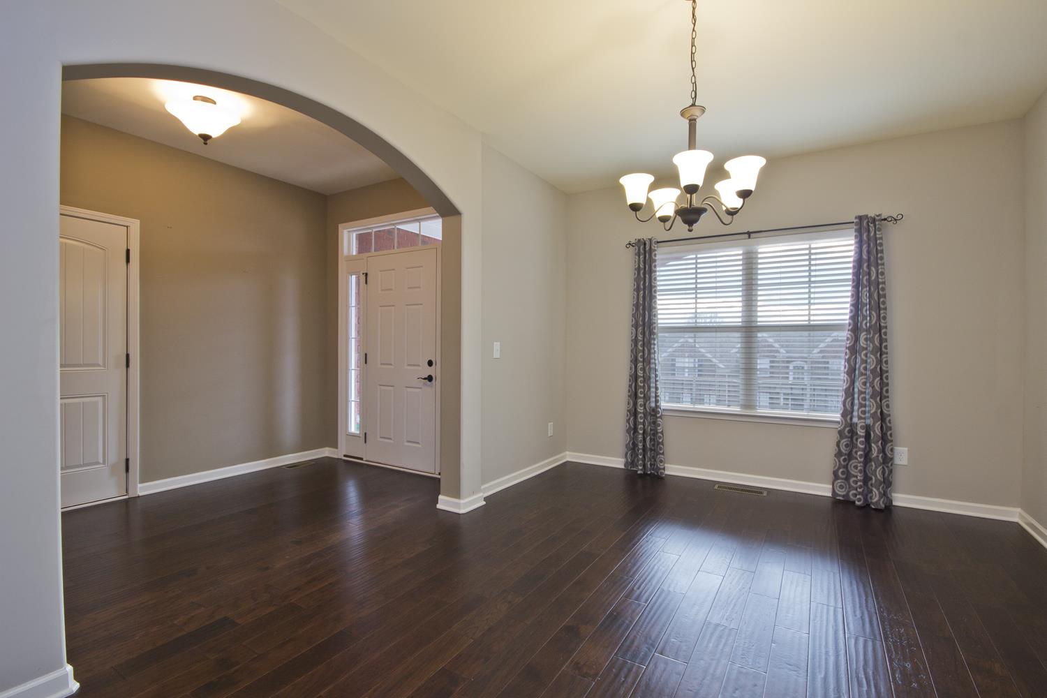 1011 Kyle Road Spring Hill, TN 37174 - Photo 5 of 30 a view of a livingroom with wooden floor and a chandelier