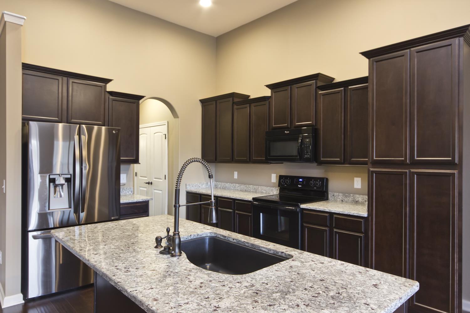 1011 Kyle Road Spring Hill, TN 37174 - Photo 6 of 30 a kitchen with granite countertop a refrigerator and a sink