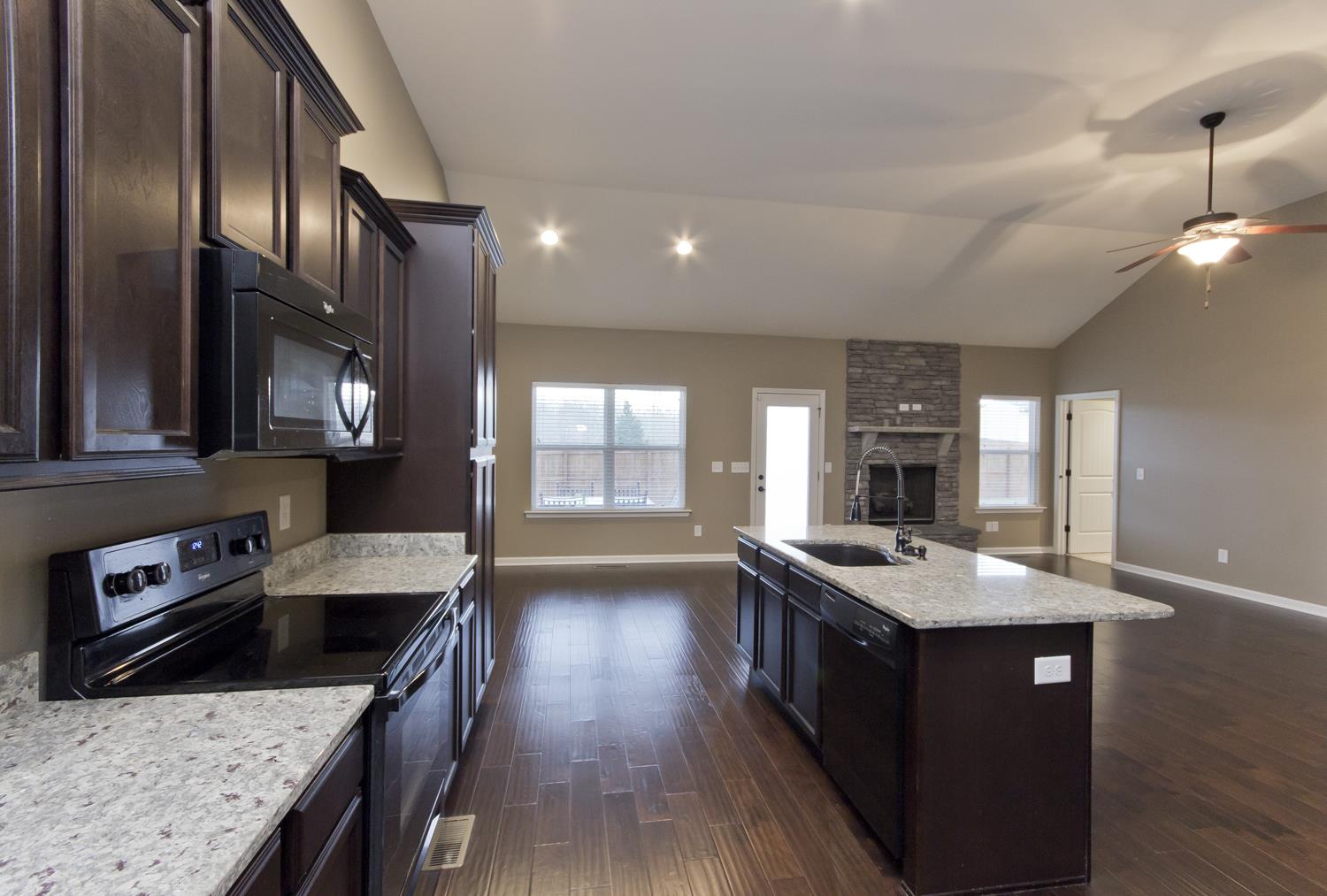 1011 Kyle Road Spring Hill, TN 37174 - Photo 7 of 30 a kitchen with stainless steel appliances granite countertop a sink stove and cabinets