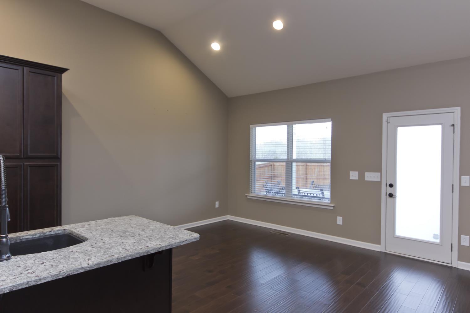 1011 Kyle Road Spring Hill, TN 37174 - Photo 8 of 30 an empty room with wooden floor and windows