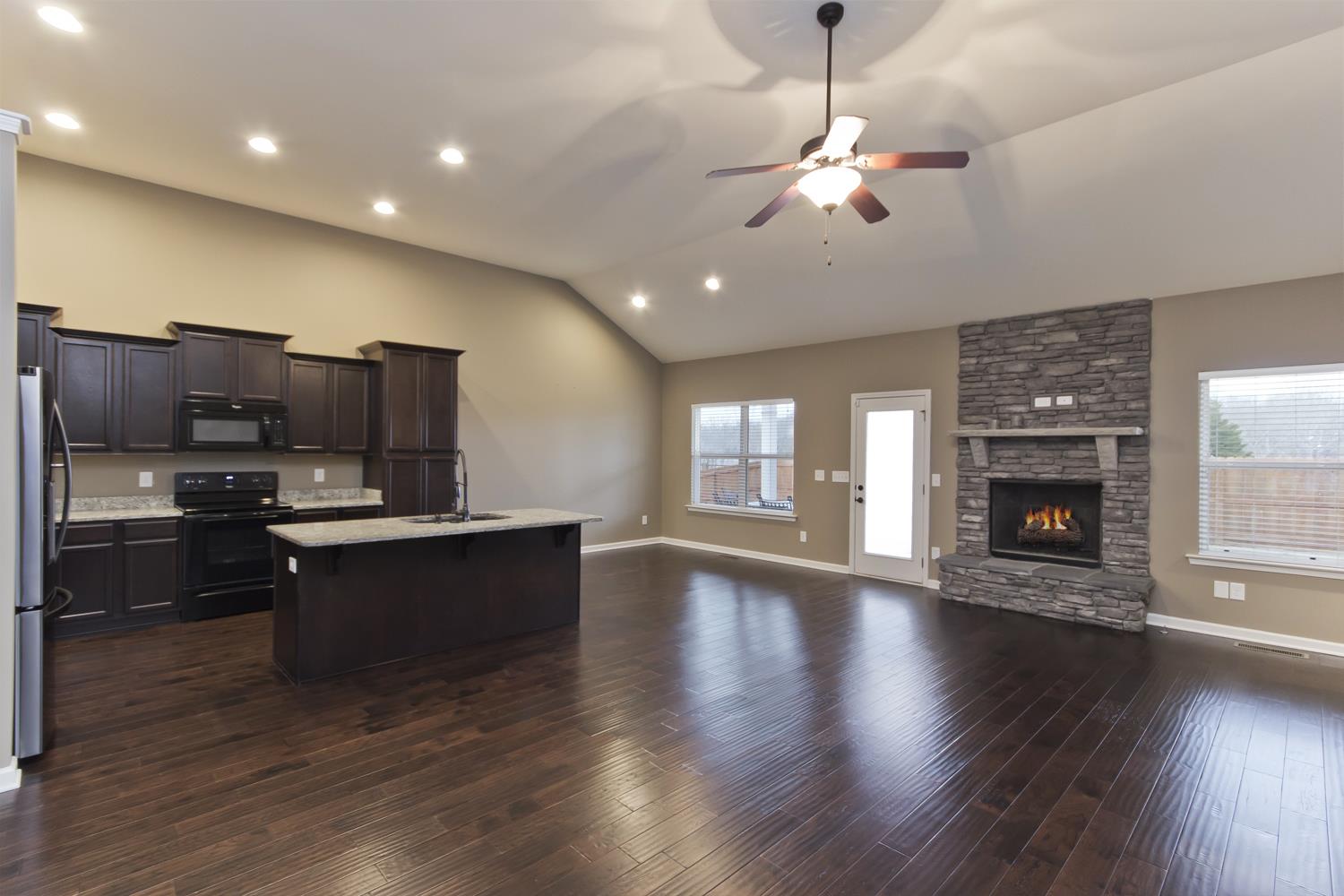 1011 Kyle Road Spring Hill, TN 37174 - Photo 9 of 30 a large kitchen with stainless steel appliances granite countertop a stove and a wooden floors