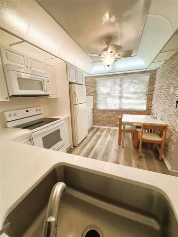 a kitchen with a refrigerator and a sink