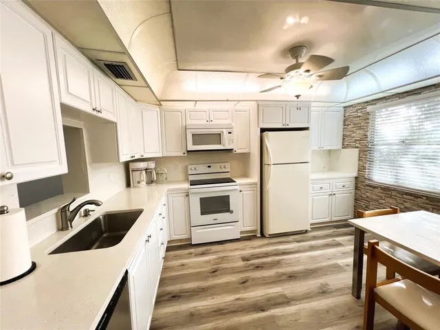 a kitchen with stainless steel appliances a stove a sink and a refrigerator