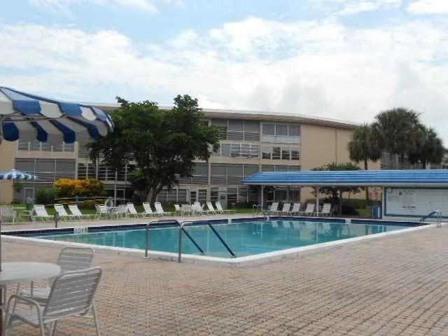 a view of pool with brick walls and plants