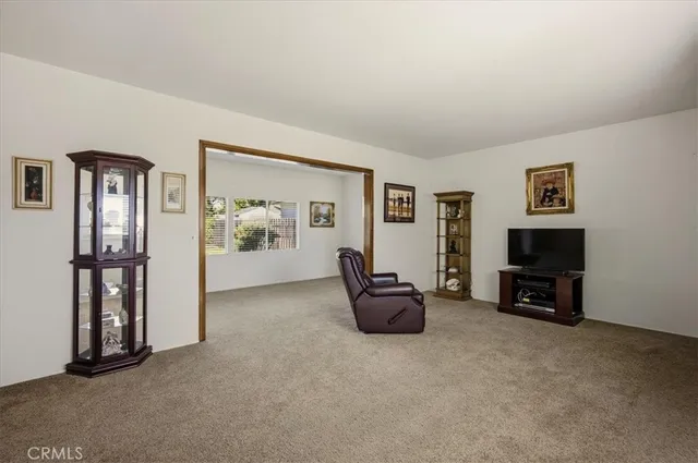 a view of a livingroom with furniture and a window