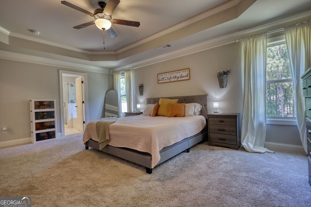 83 Bella Drive Monroe, GA 30655 - Photo 13 of 33 a bedroom with a bed and a chandelier