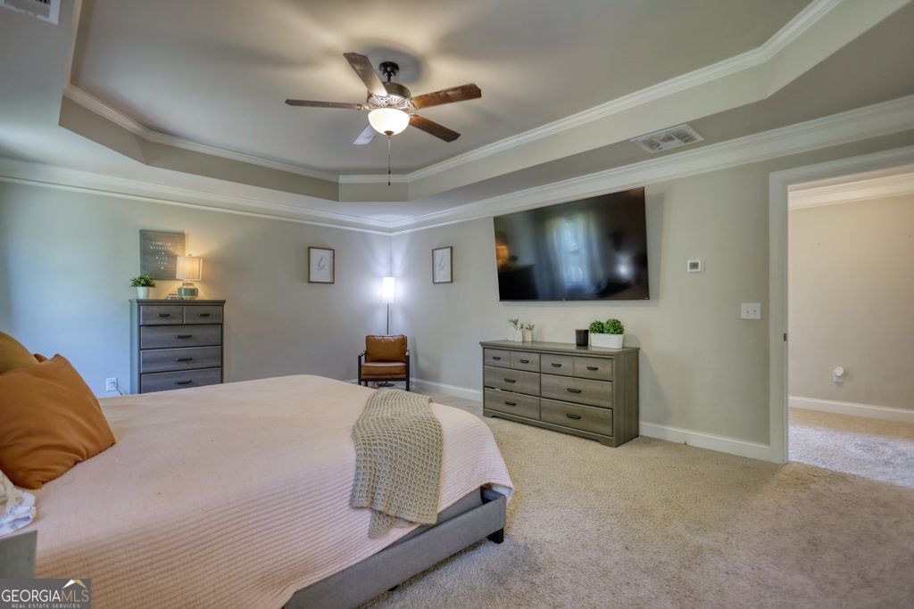 83 Bella Drive Monroe, GA 30655 - Photo 14 of 33 a bedroom with a bed and a flat screen tv