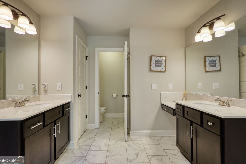 83 Bella Drive Monroe, GA 30655 - Photo 15 of 33 a bathroom with a sink vanity and a mirror