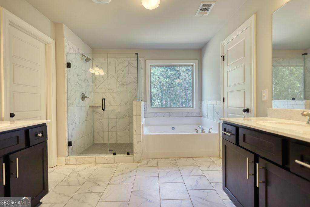 83 Bella Drive Monroe, GA 30655 - Photo 16 of 33 a bathroom with a granite countertop sink a toilet and shower