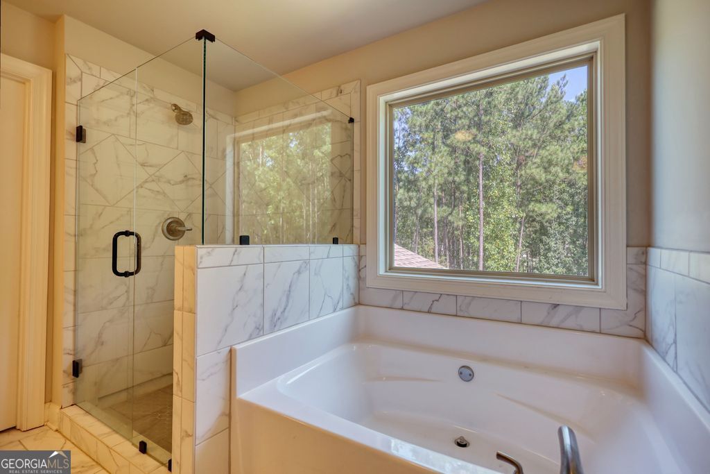 83 Bella Drive Monroe, GA 30655 - Photo 17 of 33 a bathroom with a bathtub and shower