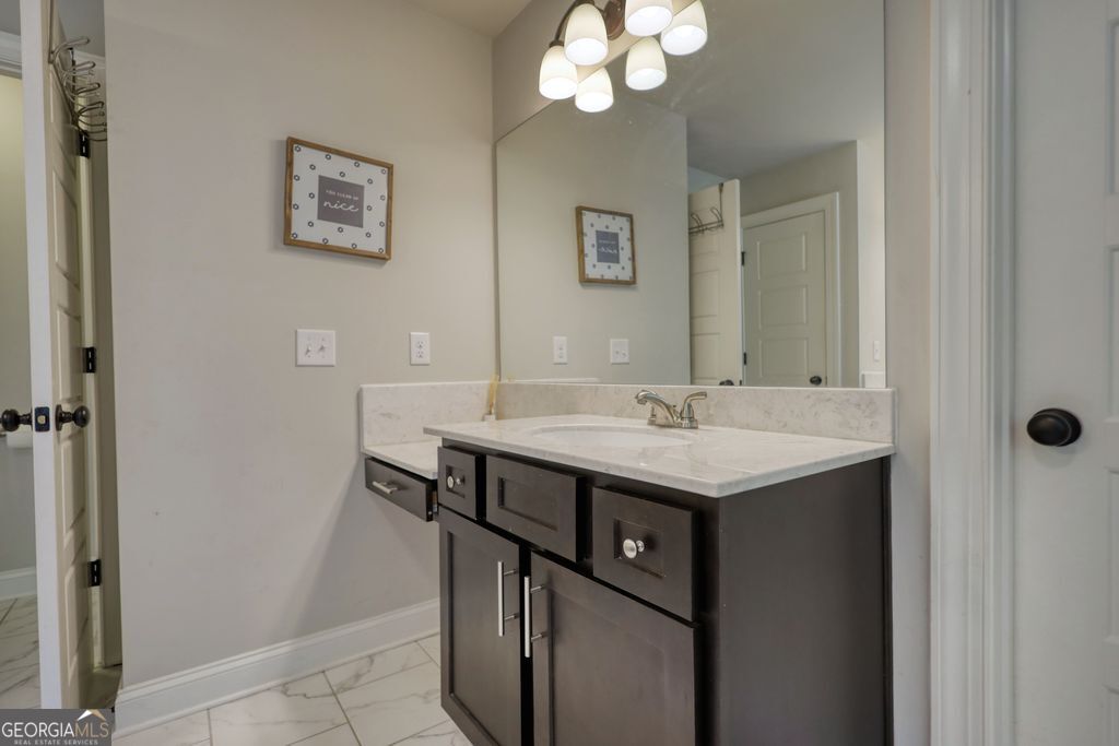 83 Bella Drive Monroe, GA 30655 - Photo 18 of 33 a bathroom with a sink a mirror and a toilet