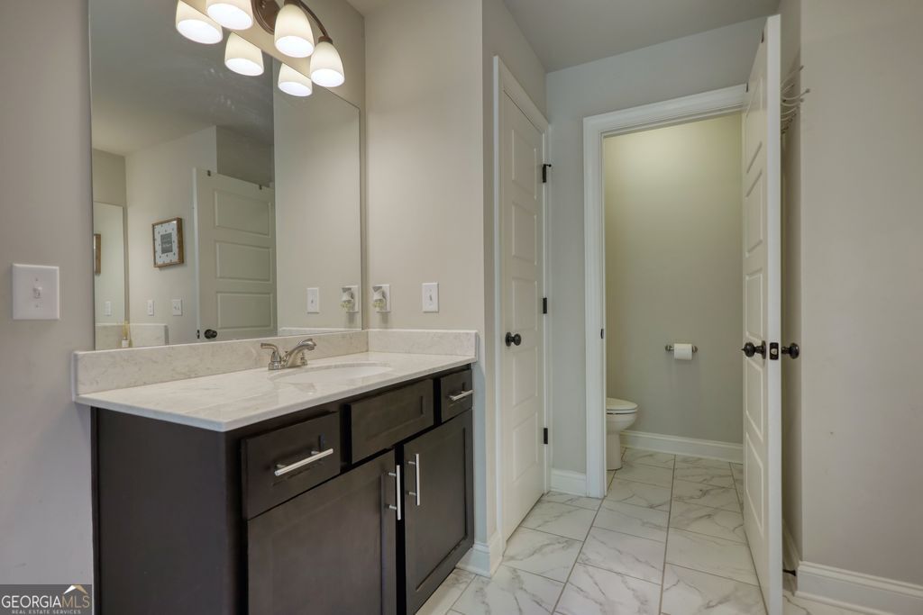 83 Bella Drive Monroe, GA 30655 - Photo 19 of 33 a bathroom with a sink a mirror and a shower