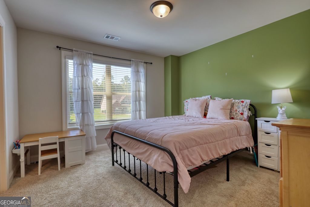83 Bella Drive Monroe, GA 30655 - Photo 20 of 33 a bedroom with a bed and a window