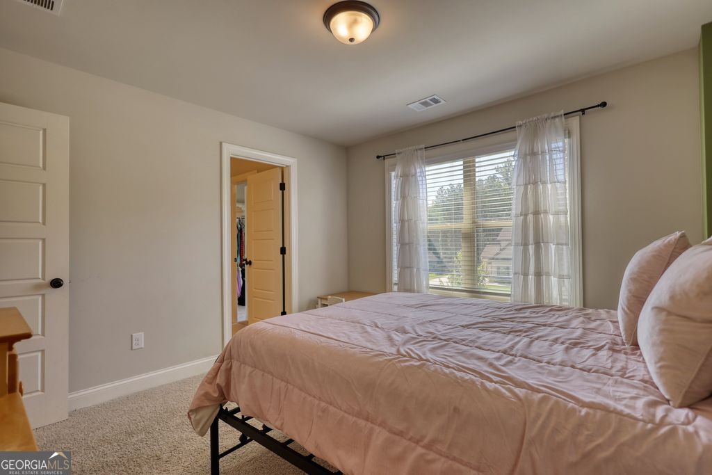 83 Bella Drive Monroe, GA 30655 - Photo 21 of 33 a bedroom with a bed and a window
