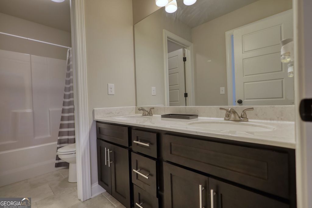 83 Bella Drive Monroe, GA 30655 - Photo 25 of 33 a bathroom with a double vanity sink a and a mirror