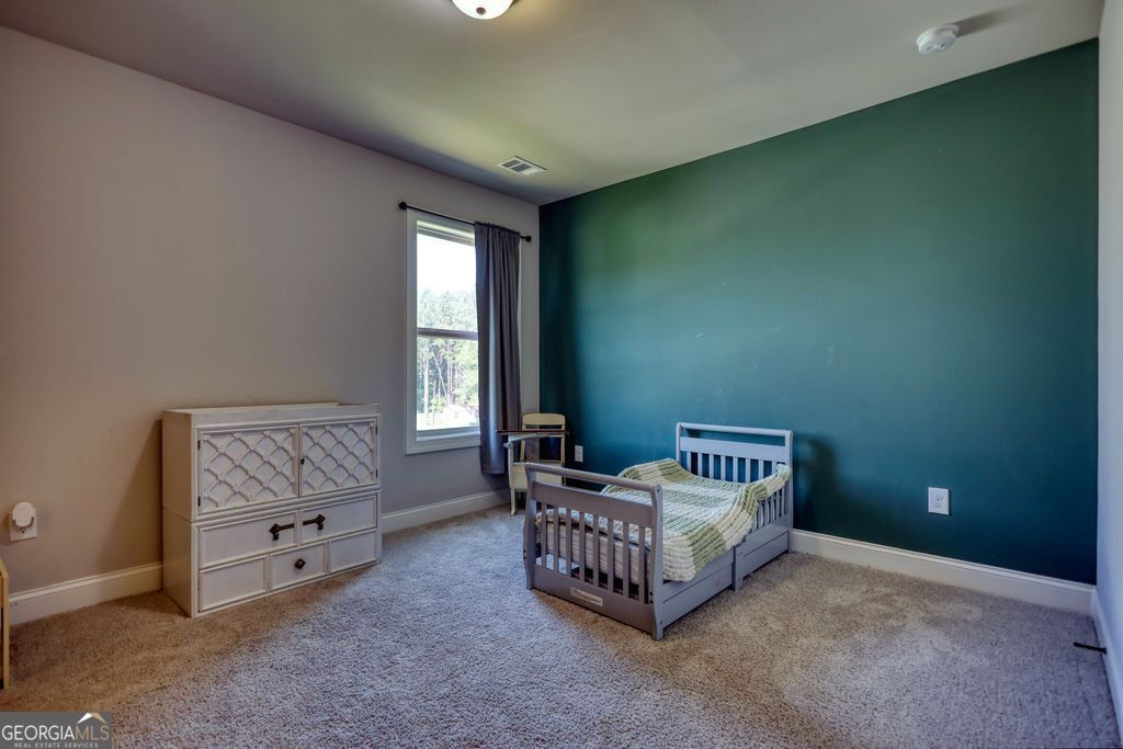 83 Bella Drive Monroe, GA 30655 - Photo 26 of 33 a room with a baby bed and a window