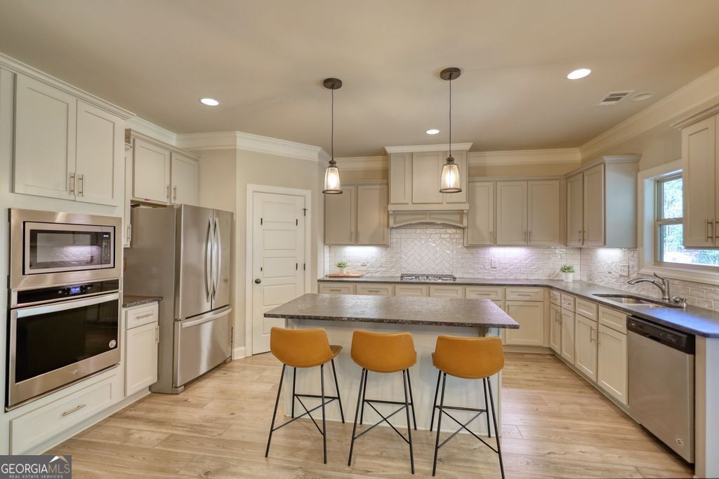 83 Bella Drive Monroe, GA 30655 - Photo 3 of 33 a large kitchen with a table and chairs in it