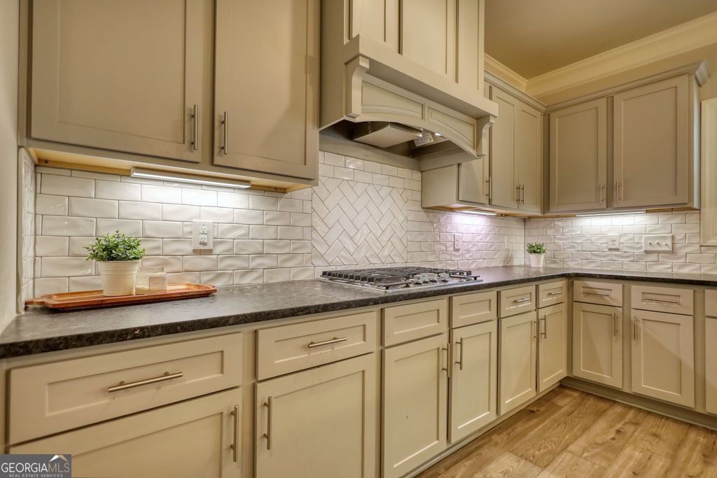 83 Bella Drive Monroe, GA 30655 - Photo 6 of 33 a kitchen with granite countertop cabinets stainless steel appliances a sink and cabinets