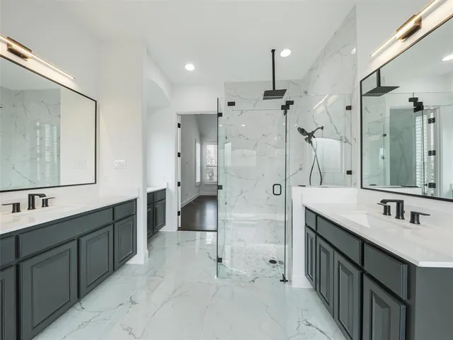 a bathroom with a double vanity sink mirror double and shower