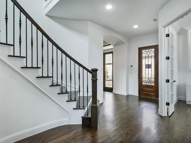 a view of an entryway with wooden floor and stairs