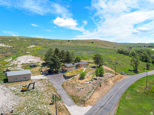 15680 North Beaver Dam Road Collinston, UT 84306 - Photo 46 of 49 Rural property featuring a single-story residence with an attached garage, a separate detached garage, and an additional shed