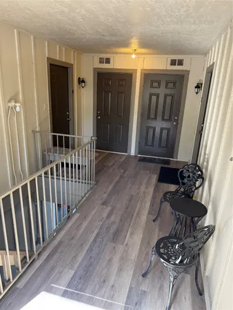 a view of a porch with wooden floor