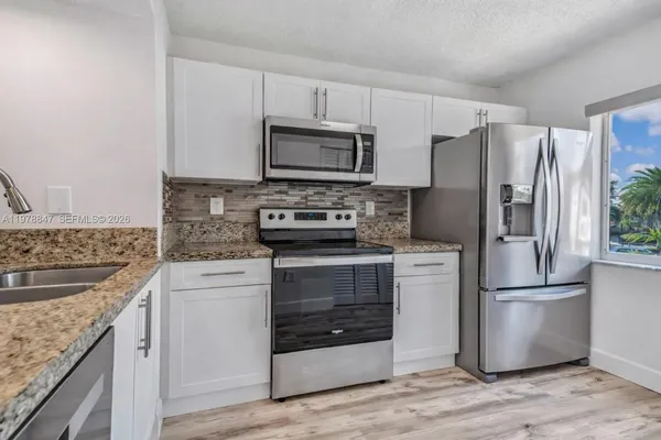 a kitchen with a refrigerator stove and microwave