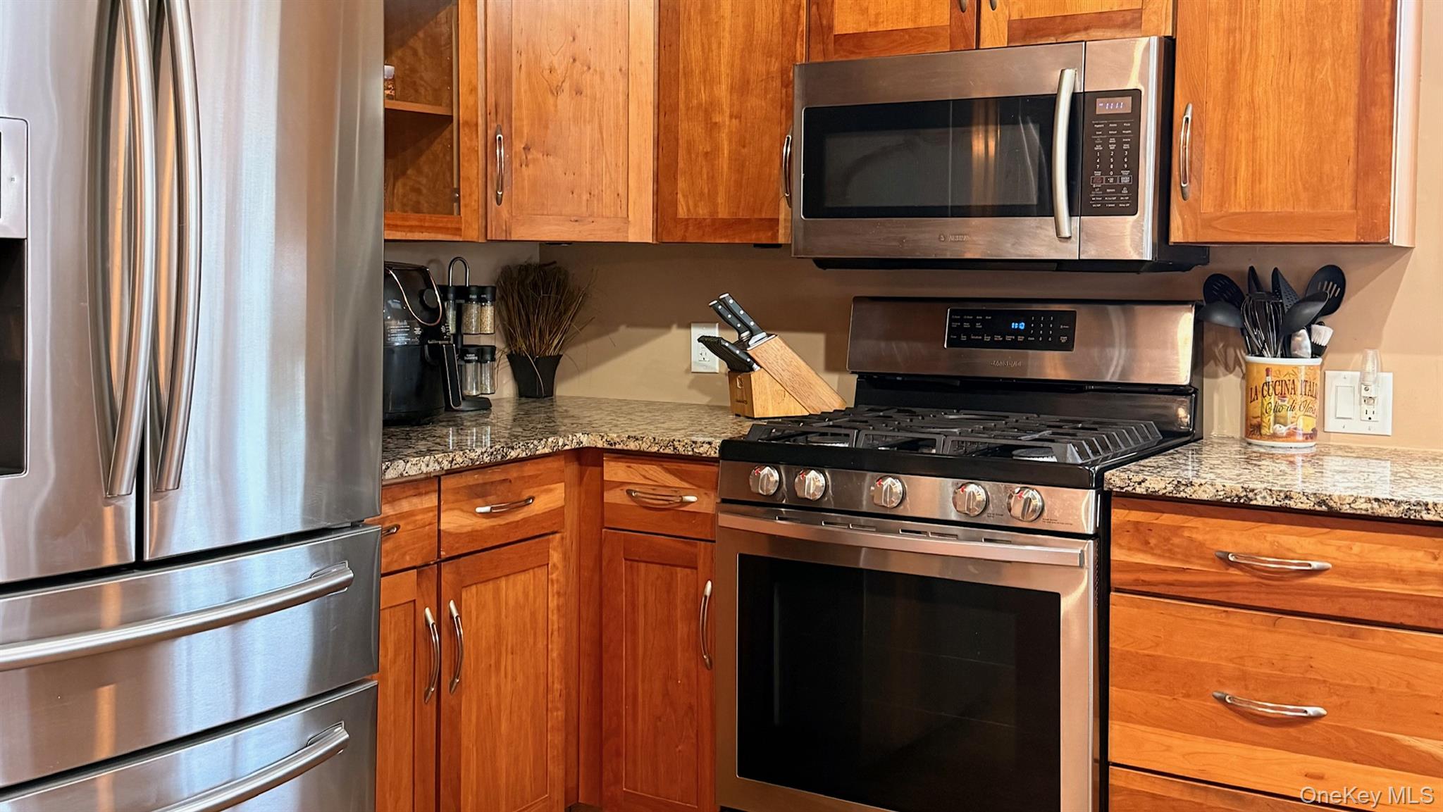 345 O'Connor Road North Babylon, NY 11703 - Photo 12 of 47 a kitchen with stainless steel appliances granite countertop a stove a sink and a microwave