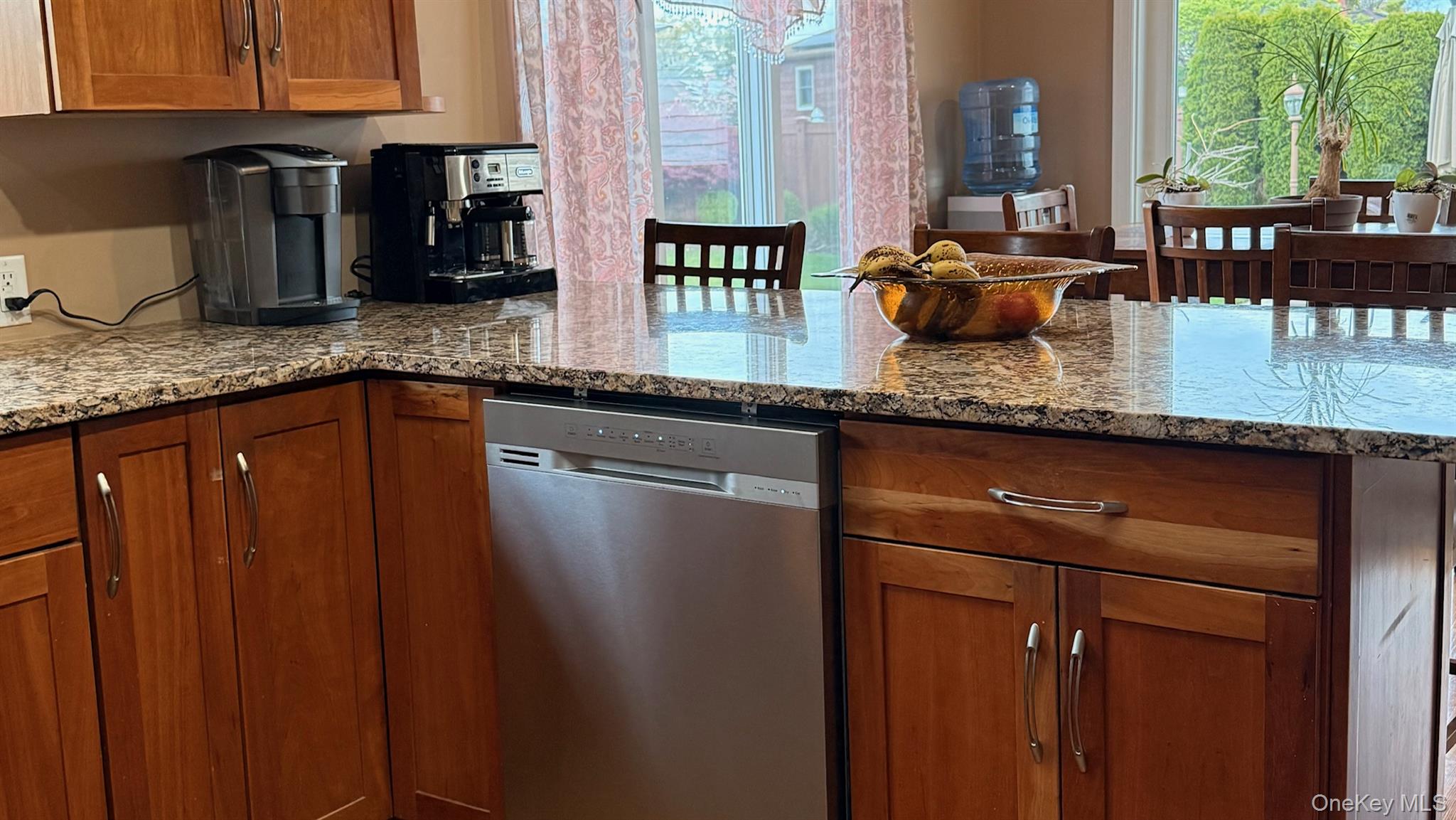 345 O'Connor Road North Babylon, NY 11703 - Photo 13 of 47 a kitchen with granite countertop a sink a stove and wooden cabinets