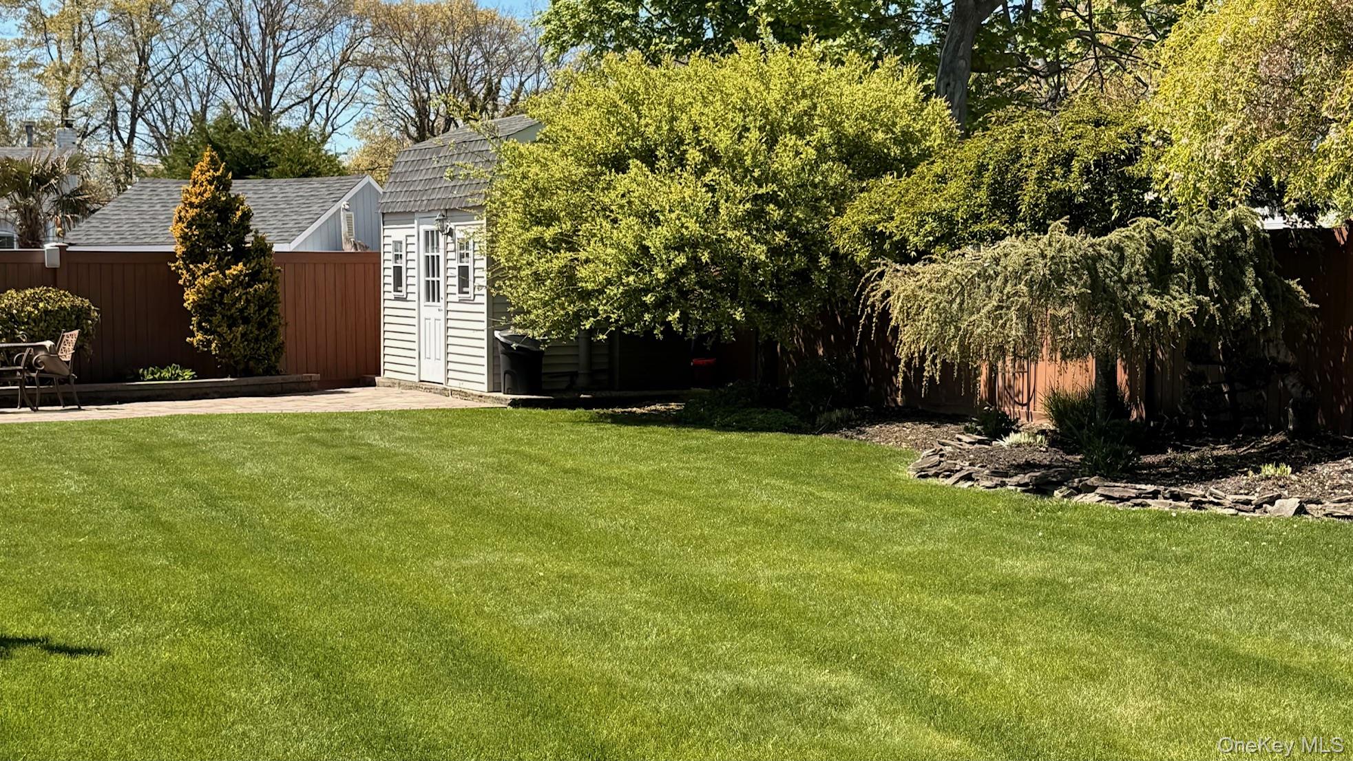 345 O'Connor Road North Babylon, NY 11703 - Photo 16 of 47 a view of a backyard with a tree