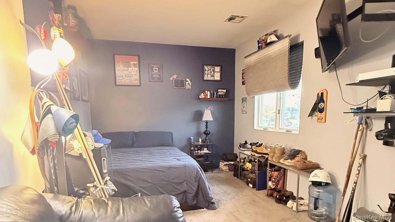 345 O'Connor Road North Babylon, NY 11703 - Photo 31 of 47 a bedroom with a bed and a chandelier