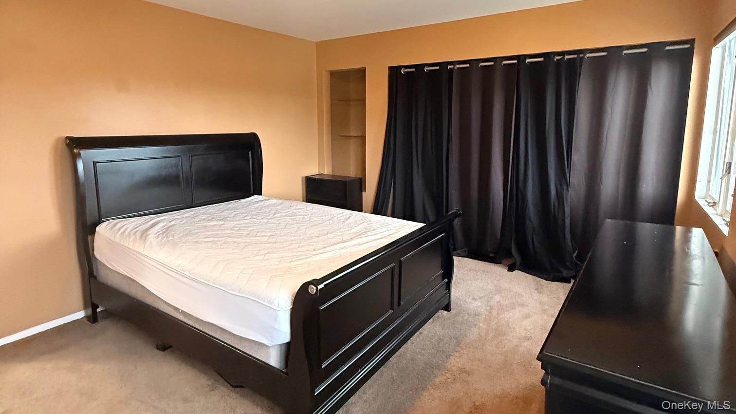 345 O'Connor Road North Babylon, NY 11703 - Photo 41 of 47 a bed sitting in a bedroom next to a window