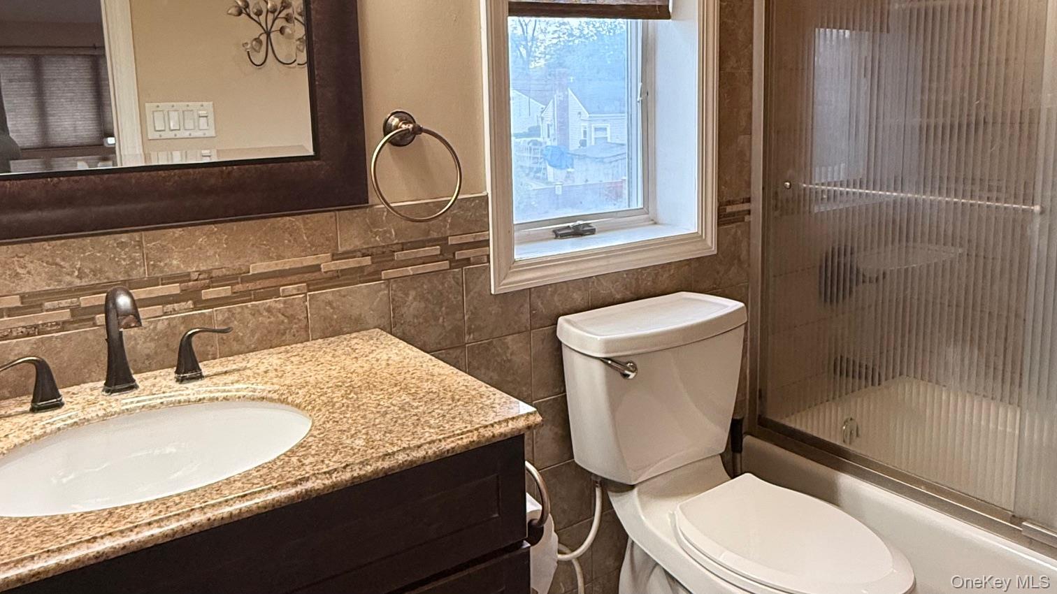 345 O'Connor Road North Babylon, NY 11703 - Photo 44 of 47 a bathroom with a granite countertop toilet sink and mirror