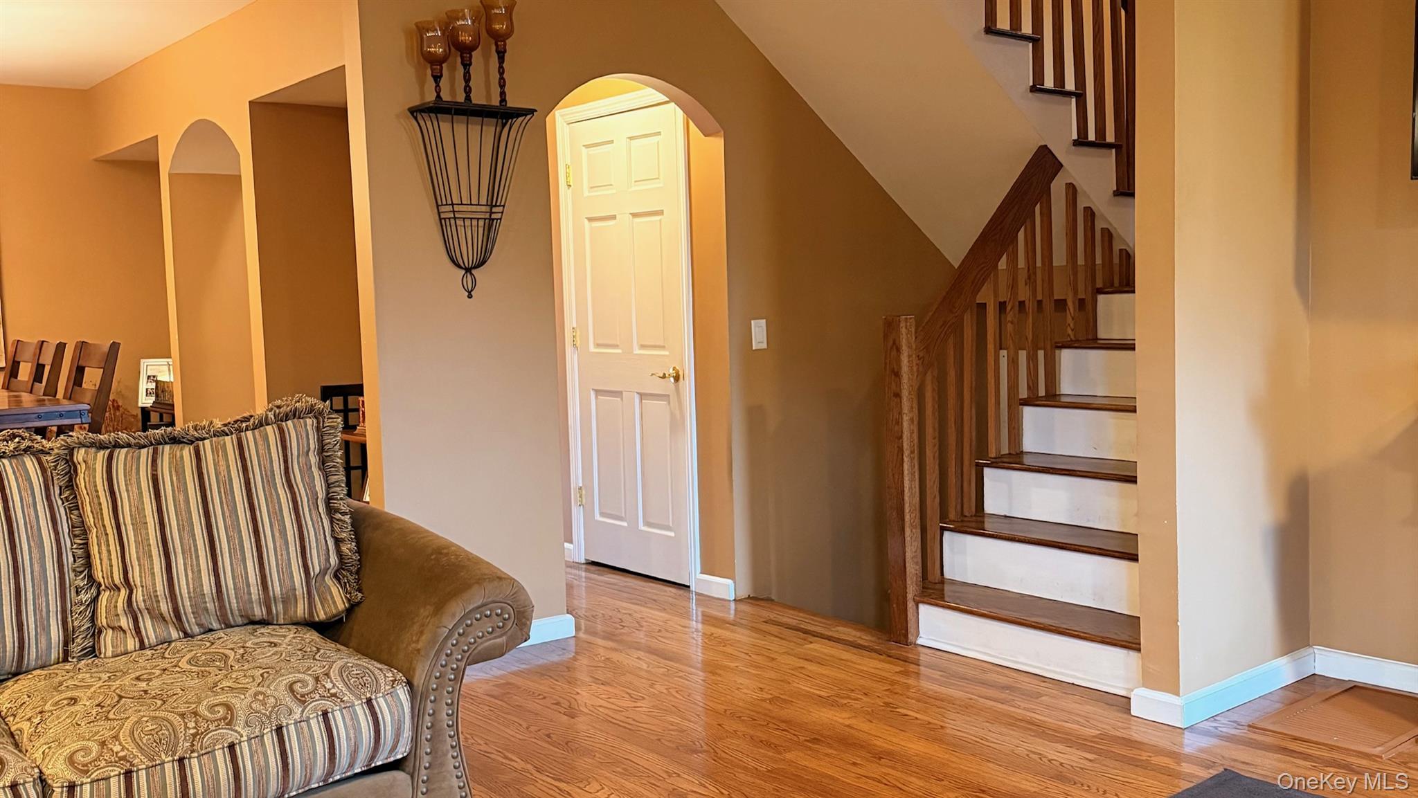 345 O'Connor Road North Babylon, NY 11703 - Photo 9 of 47 a view of a livingroom with wooden floor and staircase