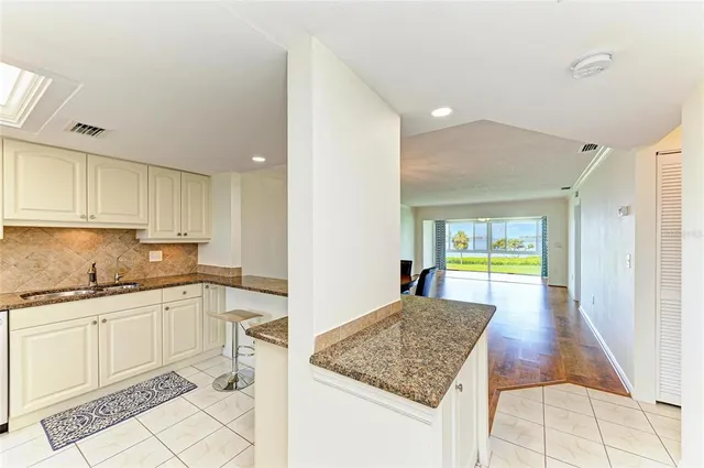 a kitchen with stainless steel appliances a stove a sink and a refrigerator