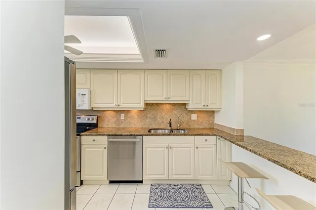 a view of a dining room with furniture a chandelier and wooden floor