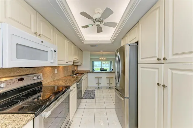 a view of a livingroom with wooden floor and a ceiling fan