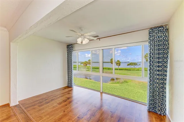 an aerial view of a house with a garden and lake view