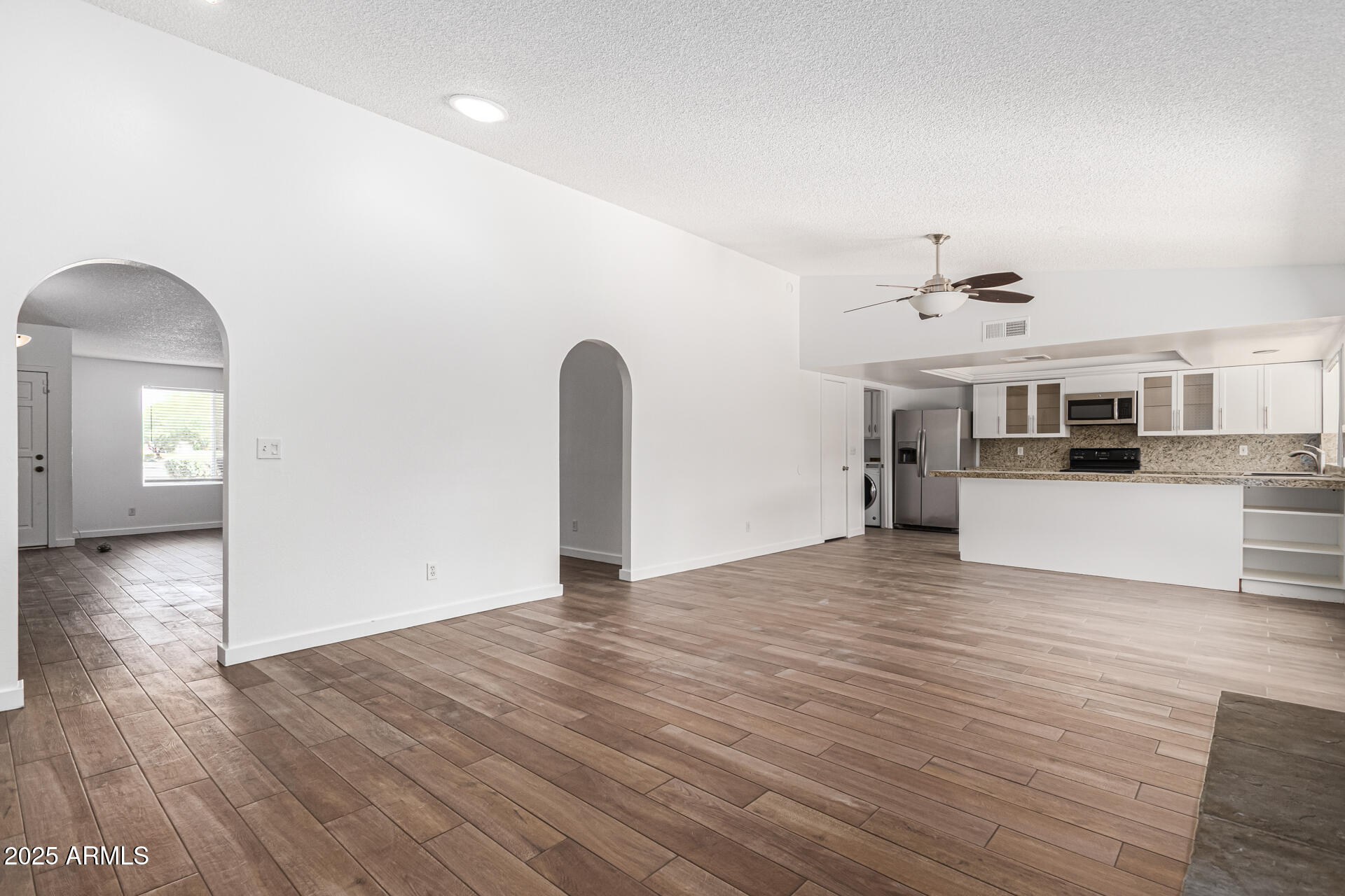 14034 North 60th Street Scottsdale, AZ 85254 - Photo 12 of 44 a view of a livingroom with a kitchen counter tops and wooden floor