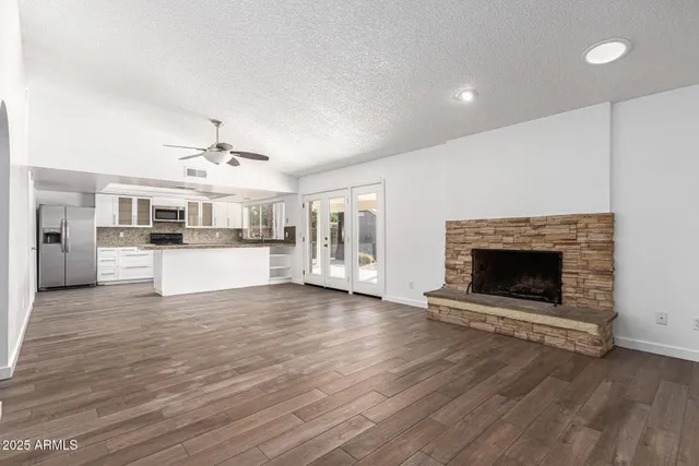 a view of a kitchen with a sink dishwasher and a fireplace