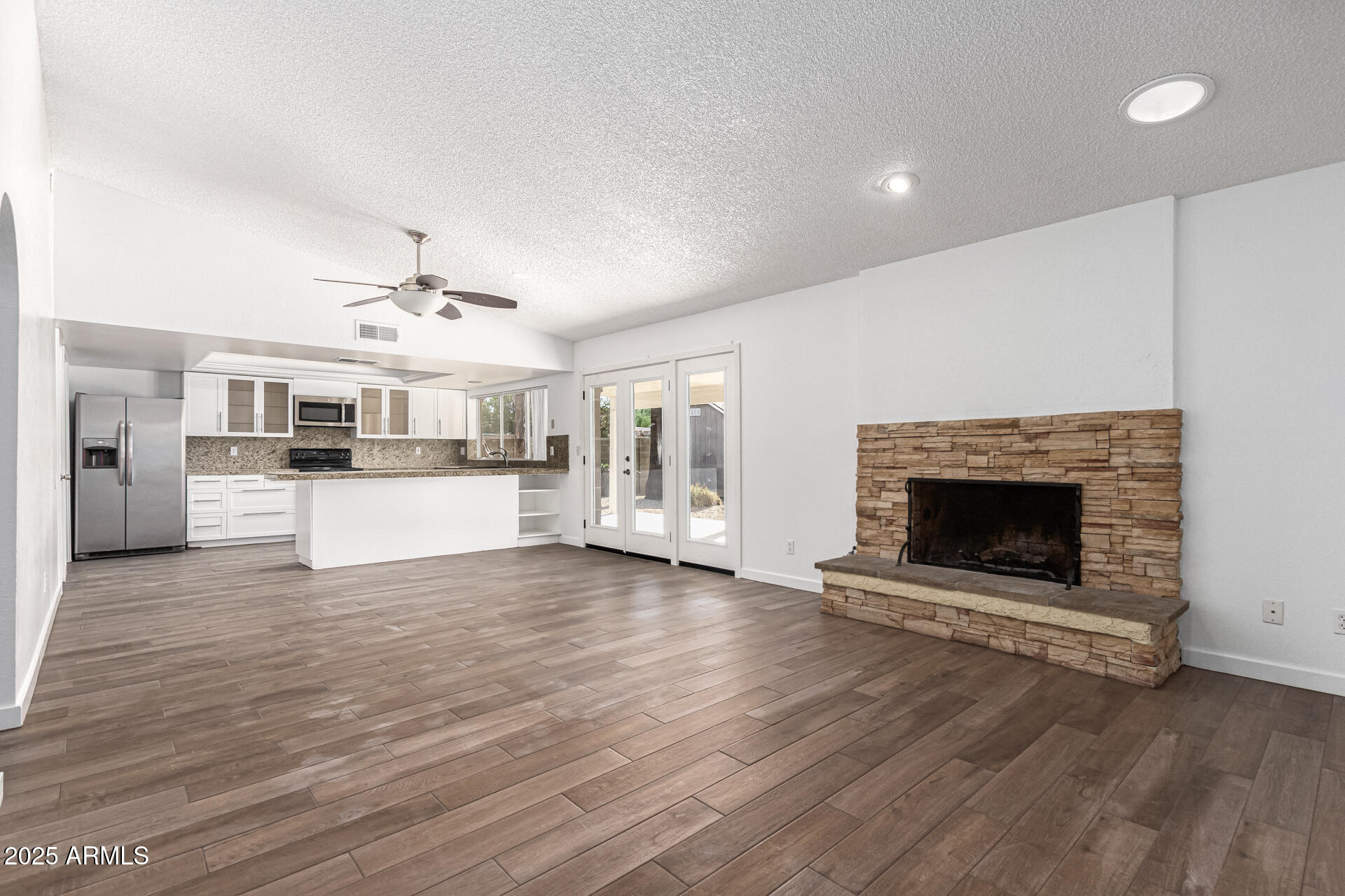 14034 North 60th Street Scottsdale, AZ 85254 - Photo 13 of 44 a view of a kitchen with a sink dishwasher and a fireplace