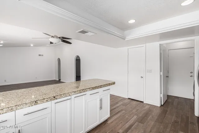a bathroom with a granite countertop sink and mirror