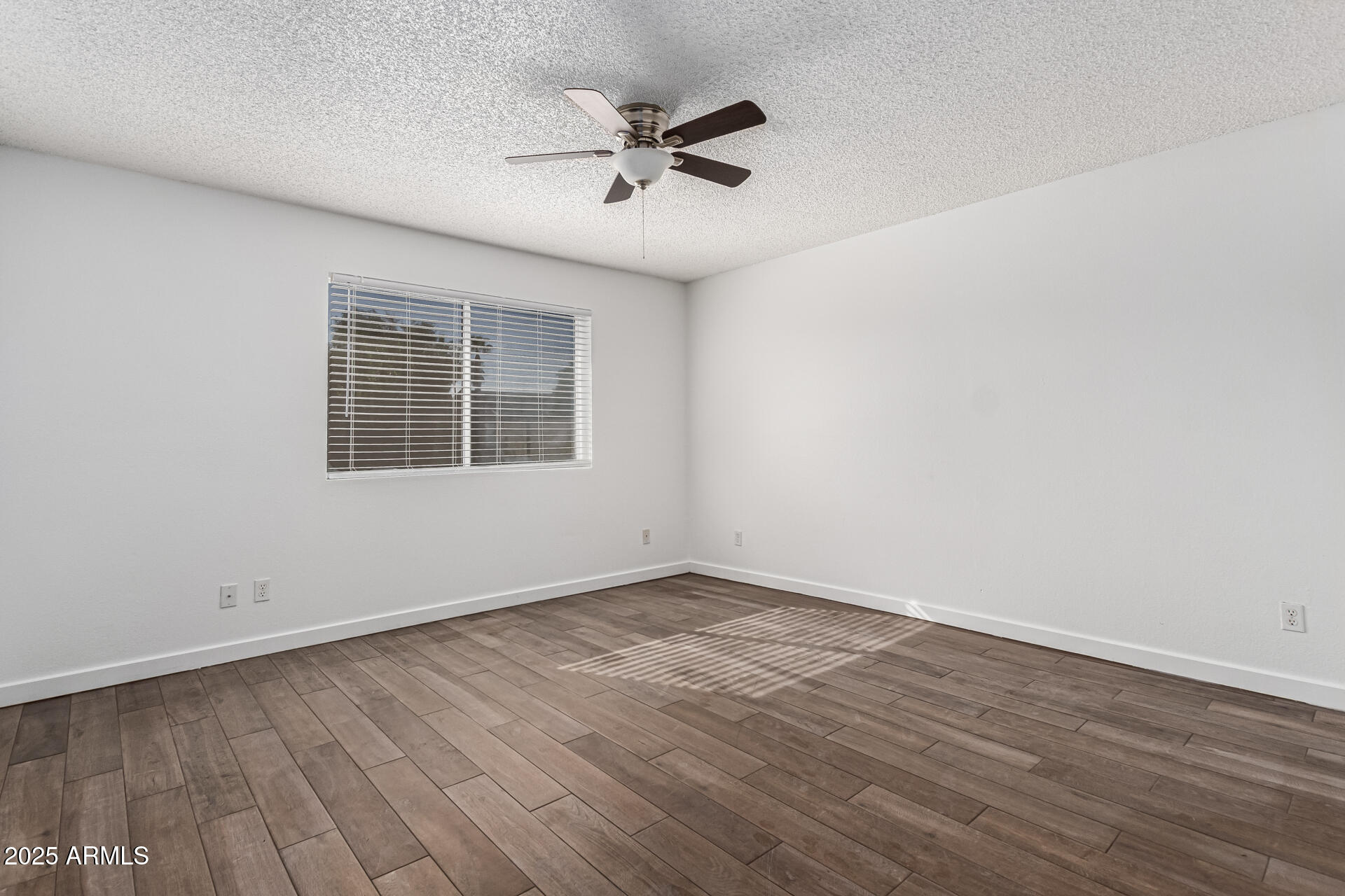 14034 North 60th Street Scottsdale, AZ 85254 - Photo 18 of 44 an empty room with wooden floor and windows