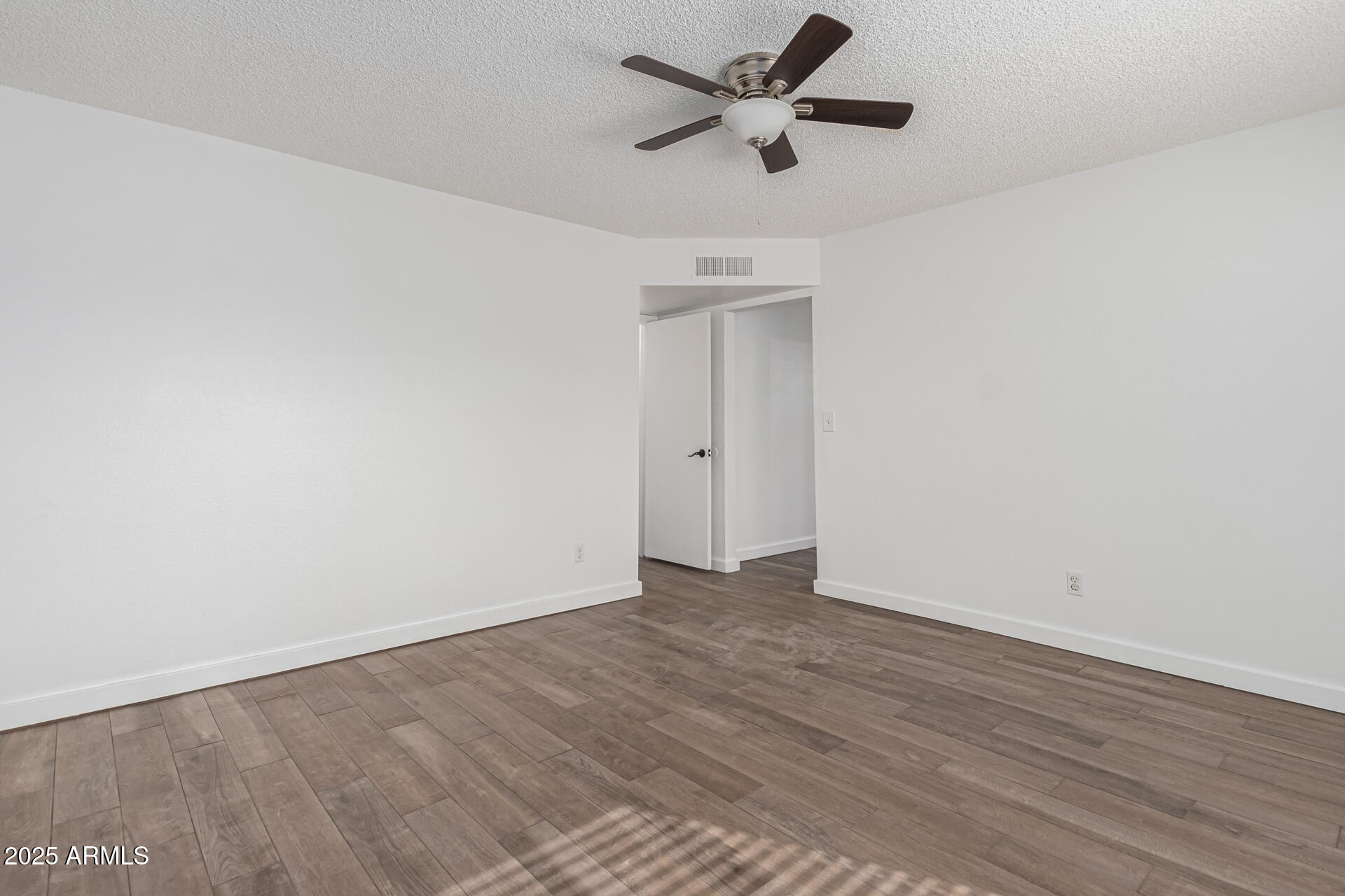 14034 North 60th Street Scottsdale, AZ 85254 - Photo 19 of 44 an empty room with wooden floor and a ceiling fan