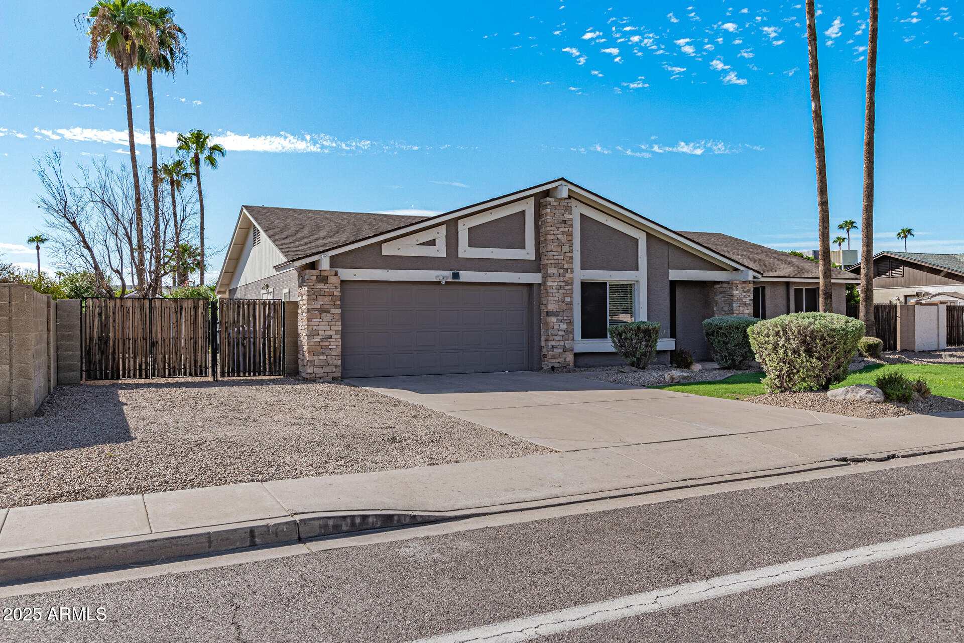 14034 North 60th Street Scottsdale, AZ 85254 - Photo 2 of 44 a front view of a house with a yard and garage
